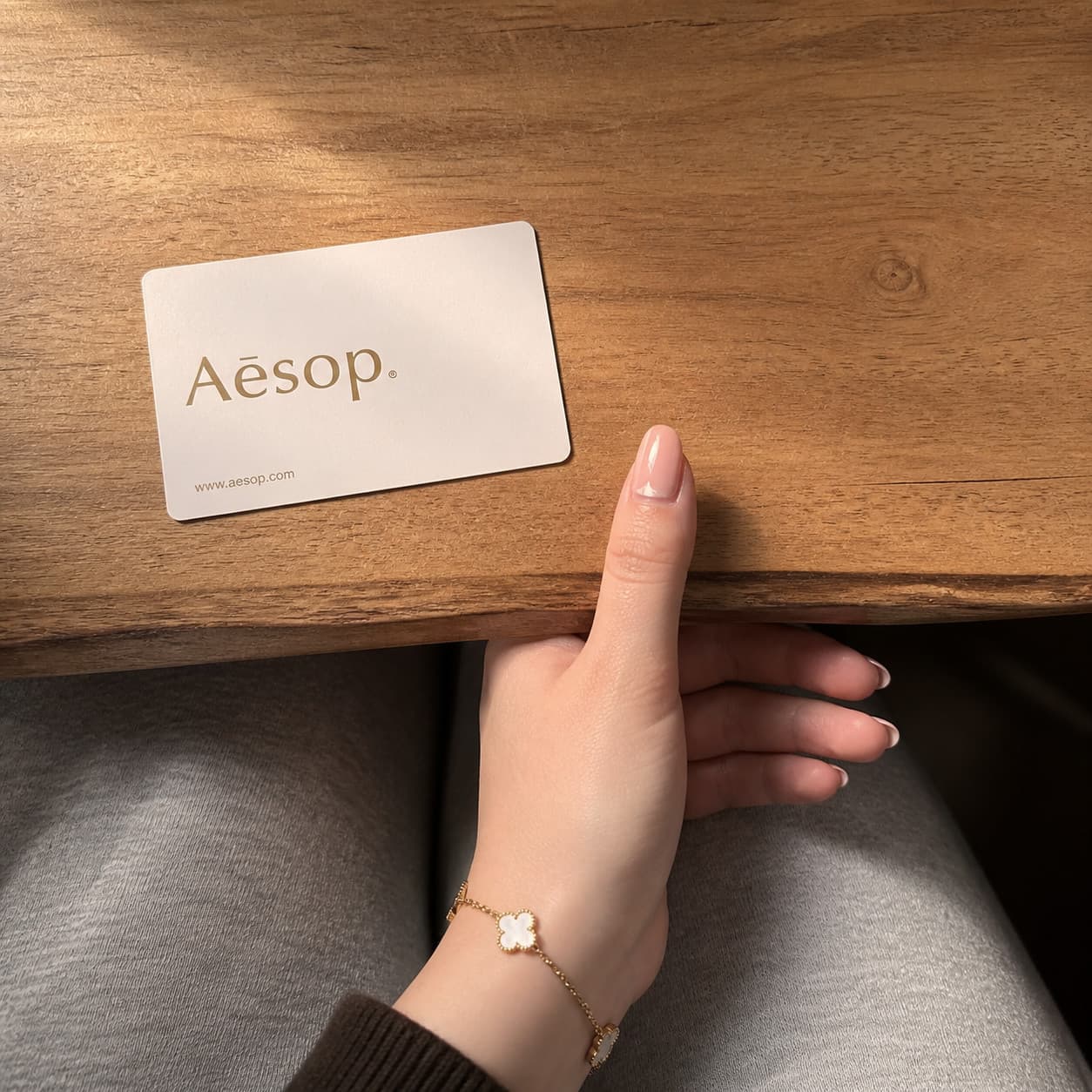 Client's thumb close-up next to a reference card.